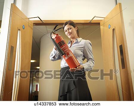 Women holding extinguisher View Large Photo Image Stock Image - Women holding extinguisher. Fotosearch