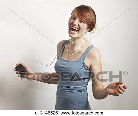 Stock Photograph - Women laughing with Mp3 Player. Fotosearch