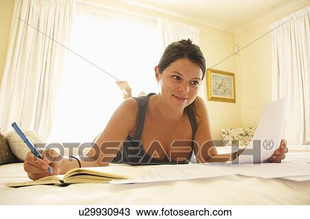 Stock Image - Women pays bills. Fotosearch