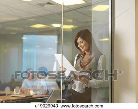 Stock Image - Women reading documents. Fotosearch