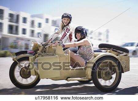 Stock Photograph - Women riding a motorbike. Fotosearch