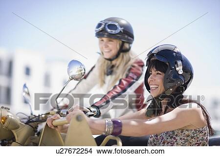 Women riding on a motorbike View Large Photo Image Picture - Women riding on a motorbike. Fotosearch