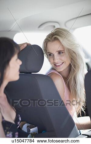Women sitting in a car View Large Photo Image Picture - Women sitting in a car. Fotosearch