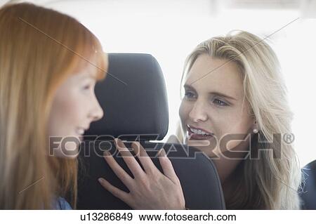 Stock Photo - Women sitting in a car. Fotosearch