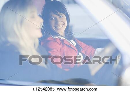 Women sitting in a car View Large Photo Image Stock Photography - Women sitting in a car. Fotosearch