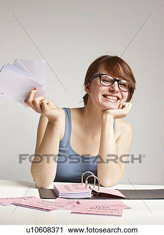 Stock Image - Women smiling doing Paperwork. Fotosearch