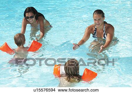 Women teaching to kids how to swim View Large Photo Image Picture - Women teaching to kids how to swim. Fotosearch