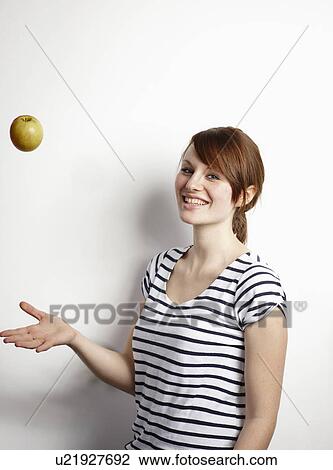 Women throwing Apple View Large Photo Image Stock Image - Women throwing Apple. Fotosearch