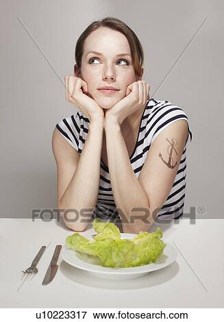 Stock Photo - Women with Anchor Tatoo and Salad Plate. Fotosearch