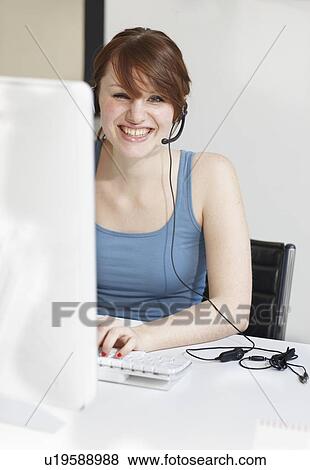 Stock Photo - Women with Headset an Computer laughing. Fotosearch