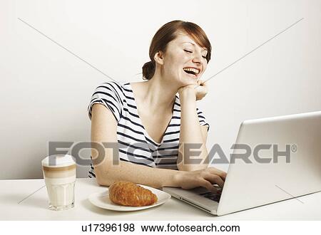 Women with laptop and breakfast View Large Photo Image Stock Photo - Women with laptop and breakfast. Fotosearch