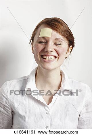 Stock Image - Women with Post-it on Forehead. Fotosearch