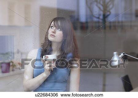 Stock Photograph - Women with Tea behind Window. Fotosearch