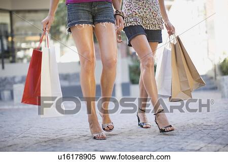 Stock Photography - Womens legs with shopping bags. Fotosearch