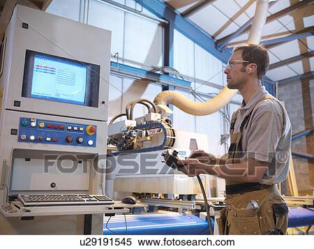 Stock Photography - Woodworker with cutting machine. Fotosearch