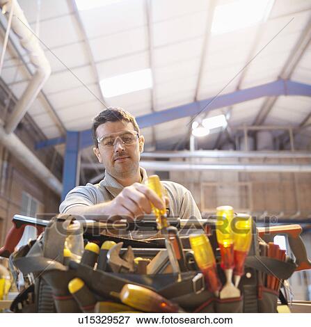 Stock Photo - Woodworker with tool kit. Fotosearch