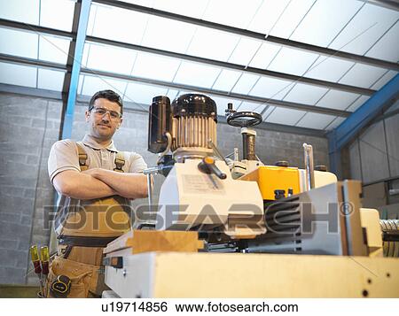 Stock Photograph - Woodworker with woodwork machine. Fotosearch
