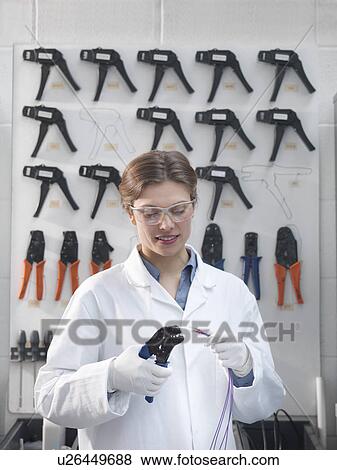 Stock Photo - Worker cutting wire with arranged tools. Fotosearch