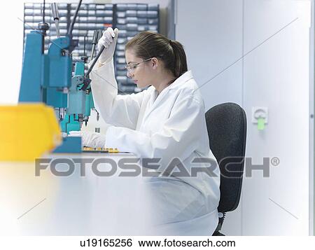 Stock Photograph - Worker in laboratory using equipment. Fotosearch