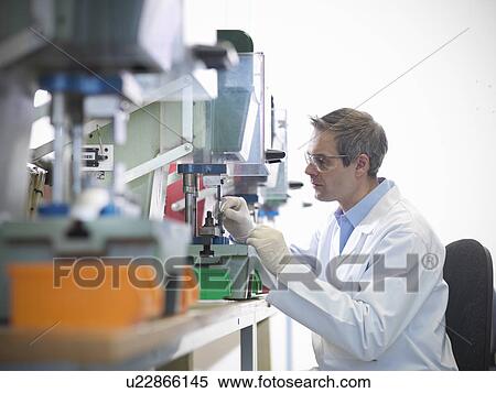Stock Photography - Worker in laboratory using equipment. Fotosearch