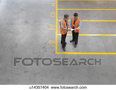 Worker in warehouse of bottling plant View Large Photo Image Picture - Worker in warehouse of bottling plant. Fotosearch