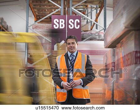 Worker in warehouse of bottling plant View Large Photo Image Stock Image - Worker in warehouse of bottling plant. Fotosearch