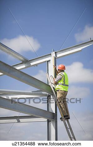 Worker inspecting a building plot View Large Photo Image Stock Photo - Worker inspecting a building plot. Fotosearch