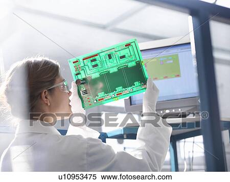 Worker inspects circuit board View Large Photo Image Stock Photography - Worker inspects circuit board. Fotosearch