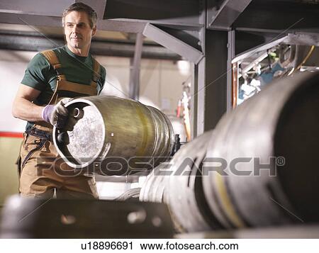 Worker lifting barrel in brewery View Large Photo Image Stock Image - Worker lifting barrel in brewery. Fotosearch