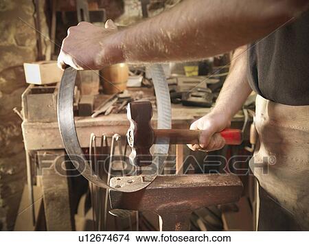 Worker making barrel in a cooperage View Large Photo Image Picture - Worker making barrel in a cooperage. Fotosearch