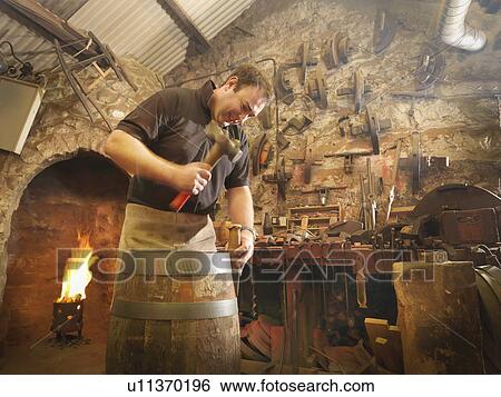 Worker making barrel in cooperage View Large Photo Image Stock Photograph - Worker making barrel in cooperage. Fotosearch