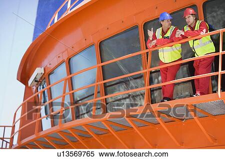 Stock Photography - Worker on a floating bridge. Fotosearch