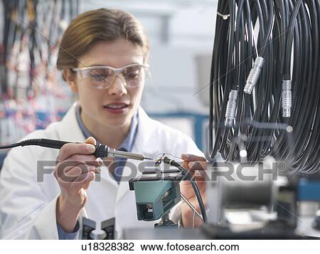 Worker soldering electronic component View Large Photo Image Stock Image - Worker soldering electronic component. Fotosearch