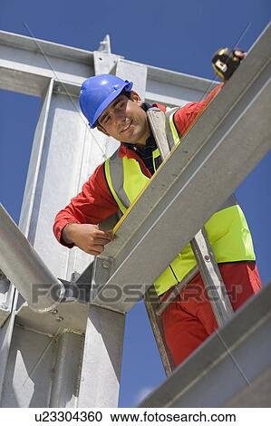 Worker standing on ladder View Large Photo Image Stock Image - Worker standing on ladder. Fotosearch