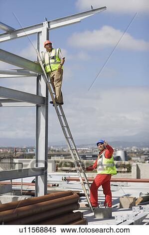 Worker standing on ladder View Large Photo Image Stock Photography - Worker standing on ladder. Fotosearch