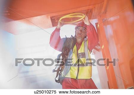 Stock Photography - Worker turning a lock. Fotosearch