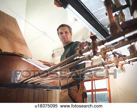 Worker turning taps at copper in brewery View Large Photo Image Stock Photography - Worker turning taps at copper in brewery. Fotosearch