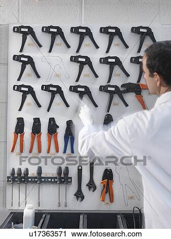 Stock Image - Worker with arranged tools. Fotosearch
