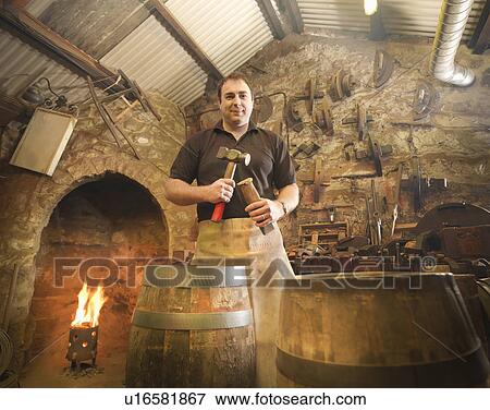 Worker with barrel in cooperage View Large Photo Image Stock Photo - Worker with barrel in cooperage. Fotosearch