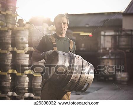 Worker with barrel outside brewery View Large Photo Image Stock Image - Worker with barrel outside brewery. Fotosearch
