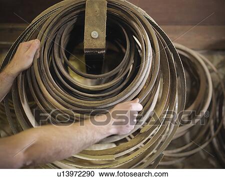 Stock Image - Worker with barrel parts in cooperage. Fotosearch