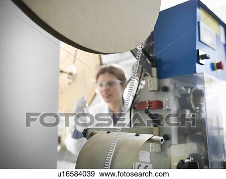 Stock Photo - Worker with electronic component machine. Fotosearch
