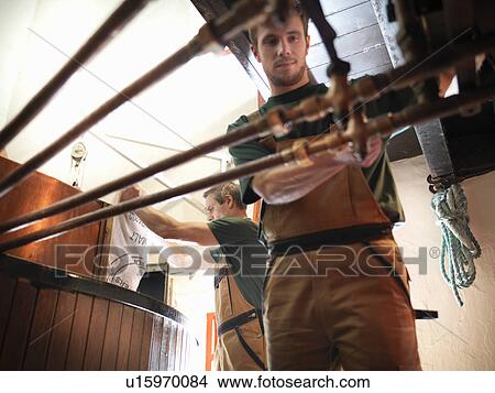 Picture - Workers at copper in brewery. Fotosearch