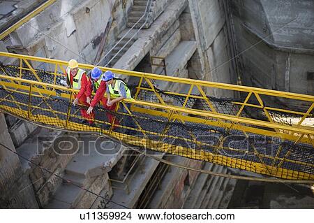Workers going over bridge in dockyard View Large Photo Image Picture - Workers going over bridge in dockyard. Fotosearch