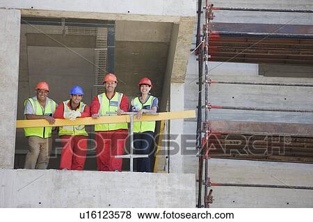Workers in a shell of building View Large Photo Image Stock Photo - Workers in a shell of building. Fotosearch