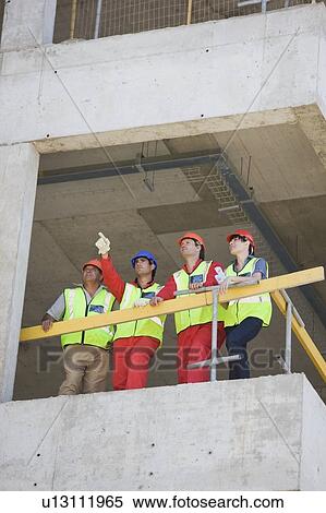 Workers in a shell of building View Large Photo Image Stock Photography - Workers in a shell of building. Fotosearch