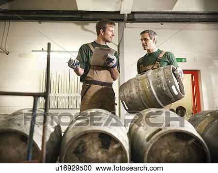 Workers in brewery with barrels View Large Photo Image Stock Image - Workers in brewery with barrels. Fotosearch