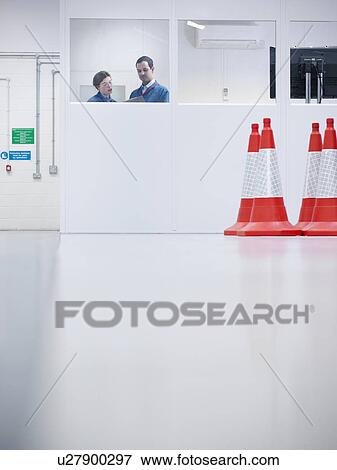 Workers in office with hazard cones View Large Photo Image Stock Photo - Workers in office with hazard cones. Fotosearch