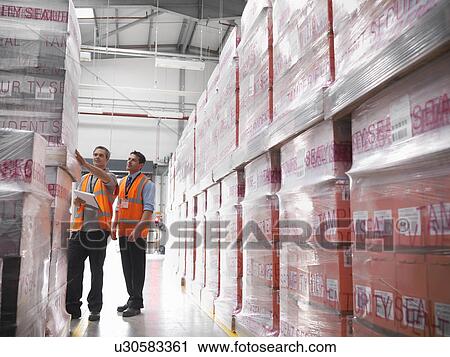 Workers in warehouse of bottling plant View Large Photo Image Stock Image - Workers in warehouse of bottling plant. Fotosearch