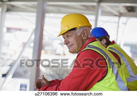 Stock Photograph - Workers looking at a building site. Fotosearch